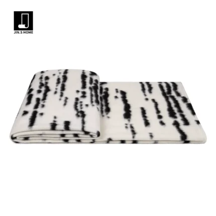 Showroom Hotel Villa: Italian-style modern luxury sofa with throw and bedspread; black-and-white tweed striped footboard throw