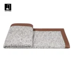 Showroom hotel villa: Italian-style luxury sofa with throw and bedspread; coffee-colored leather-trimmed textured bedside throw