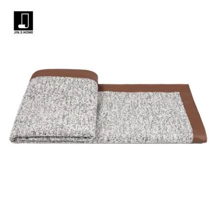 Showroom hotel villa: Italian-style luxury sofa with throw and bedspread; coffee-colored leather-trimmed textured bedside throw